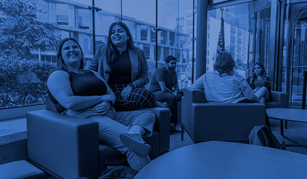 Students sit together in law school lobby